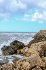 Fototapeta na wymiar Waves crashing against stones on the beach, Montenegro