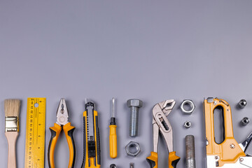 Working tools background. Screwdriver, tape measure, wrench, knife, pliers, pencils, ruler, pliers,...