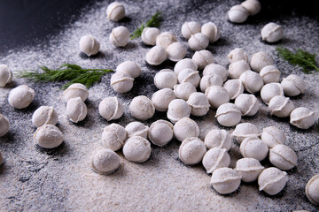 Raw dumplings background on a dark background