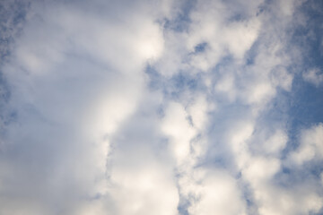 Small clouds scattered in the blue sky.