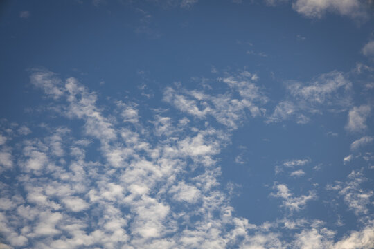 Small clouds scattered in the blue sky.