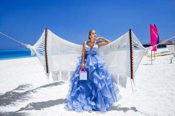 Luxury fashion. Elegant fashion model. Stylish female model in elegant long gown dress on the...