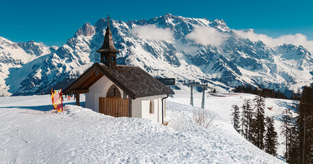 Winter landscape with a chapel and the famous Hochkoenig summit in the background at Maria Alm, Salzburg, Austria