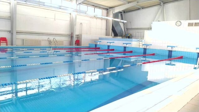 Swimming pool with clean, blue, bubbling water in the sports complex.