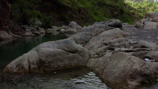 Close aerial view of a river in between the mountains