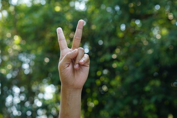 two finger human hand green bokeh background