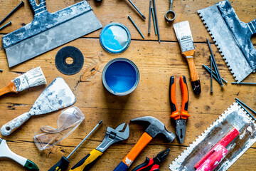 builder work with professional repairing implements set on wooden background top view