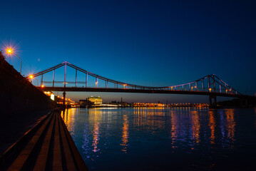 Night view of pedestrian bridge on Dnipro in Kiev Ukraine