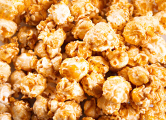 Caramel popcorn snack background texture. Close up. Top view.