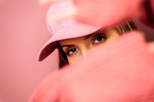 Woman in cap showing stop gesture