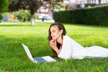 young woman and laptop in the park