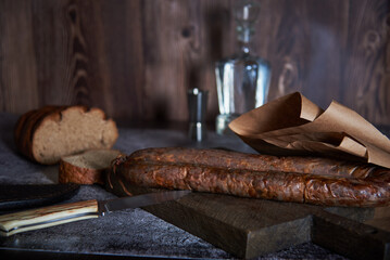  Still life with a hunting sausage decanter and a hunting knife.