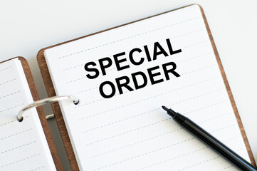 Text sign showing Special Order on an open notepad on the table