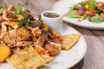 grilled and minced chicken, beef, and pork meats on plate on the table, close-up image