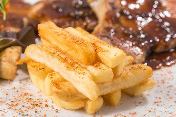 spicy and toasted french fries, on the plate, close-up