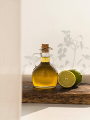 olive oil in glass bottle on wooden board and white background.