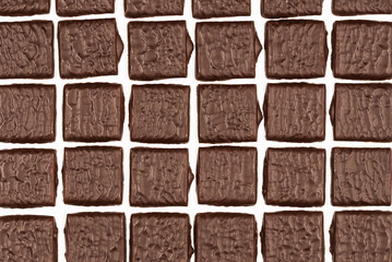 Dark chocolate candies isolated on white background.