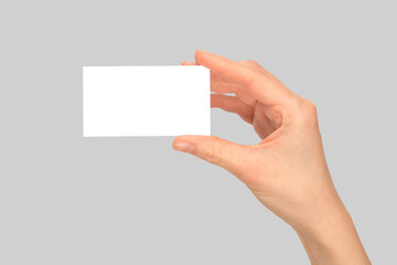 Obraz premium Empty card in woman hand isolated on grey background.