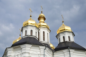 Fototapeta na wymiar Gilded domes of an ancient Orthodox church against the sky. Catherine's Church
