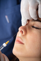 Female cosmetology in a beauty salon. Doctor nose tip correction and lifting.
