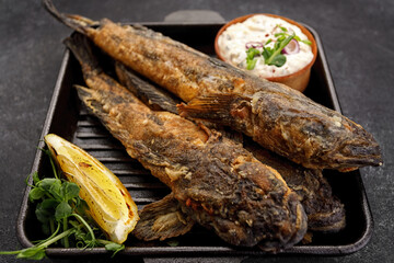 Fried fish Black Sea goby, on a dark background