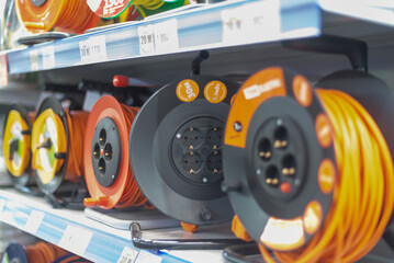 Electrical extension cords (wires) on a shelf in a store.