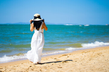 Fototapeta na wymiar girl in the sea on a beach on a clear day