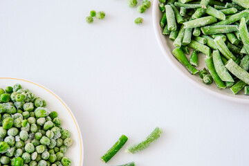 Frozen fresh peas on a light background. copyspace. Peas with ice crystals. Peas from the freezer. Peas in a light plate.