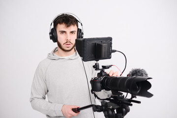 portrait of a young man video camera operator making interview in professionnal broadcast tv movie studio film production with a dslr camera