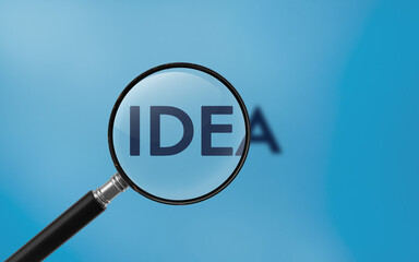Idea Text On A Magnifier Against Blue Background