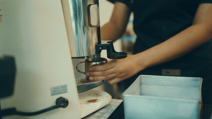 Employees make coffee in the shop for customers.