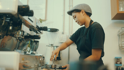 Employees make coffee in the shop for customers.