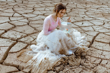 Climate change and global warming concept girl with water saves fish 