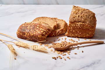 A loaf of sourdough rye bread on a rustic wooden board.