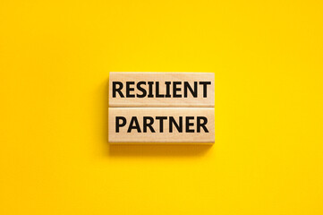 Resilient partner symbol. Concept words Resilient partner on wooden blocks on a beautiful yellow table yellow background. Business resilience and resilient partner concept, copy space.
