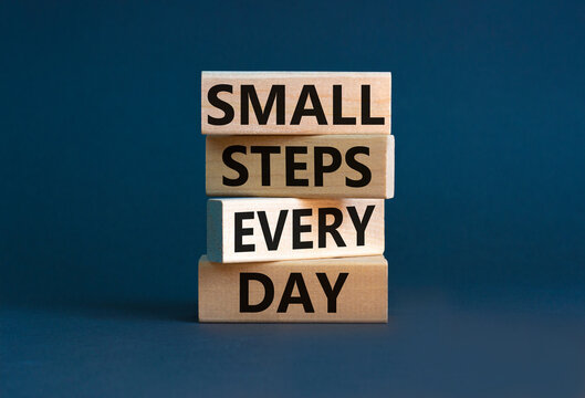 Small steps every day symbol. Concept words Small steps every day on wooden blocks. Beautiful grey table grey background. Small steps every day business concept. Copy space.