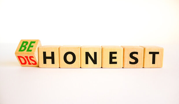 Be honest or dishonest symbol. Turned cube and changed concept words Dishonest to Be honest. Beautiful white table white background. Business and be honest or dishonest concept. Copy space.