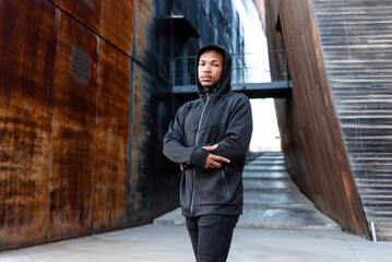 Handsome young African American man with dreadlocks in an urban setting