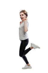 Beautiful woman is jumping. Young laughing blonde woman in black leggings and a gray tank top. Positivity, activity and movement. Isolated on white background. Vertical.