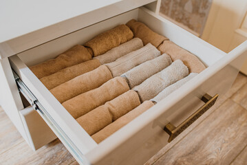 Obraz na płótnie Canvas close up of an open drawer with folded towels..