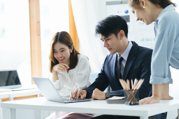 Smiling diverse colleagues gather in boardroom brainstorm discuss financial statistics together, happy multiracial coworkers have fun cooperating working together at office meeting, teamwork concept