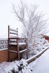 Cute giant handmade wooden chair seen on Route 66 after rare snowfall, Holbrook, Arizona, USA