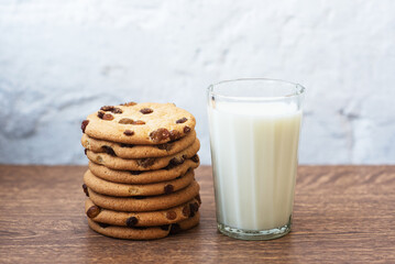 Fragrant, tasty, homemade cookies with raisins and a glass of fresh milk on the table. Delicious, hearty, healthy breakfast. Copy space, high resolution
