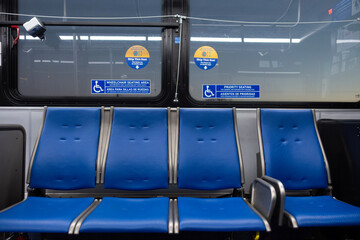 Bus seats inside a bus with disabled stickers