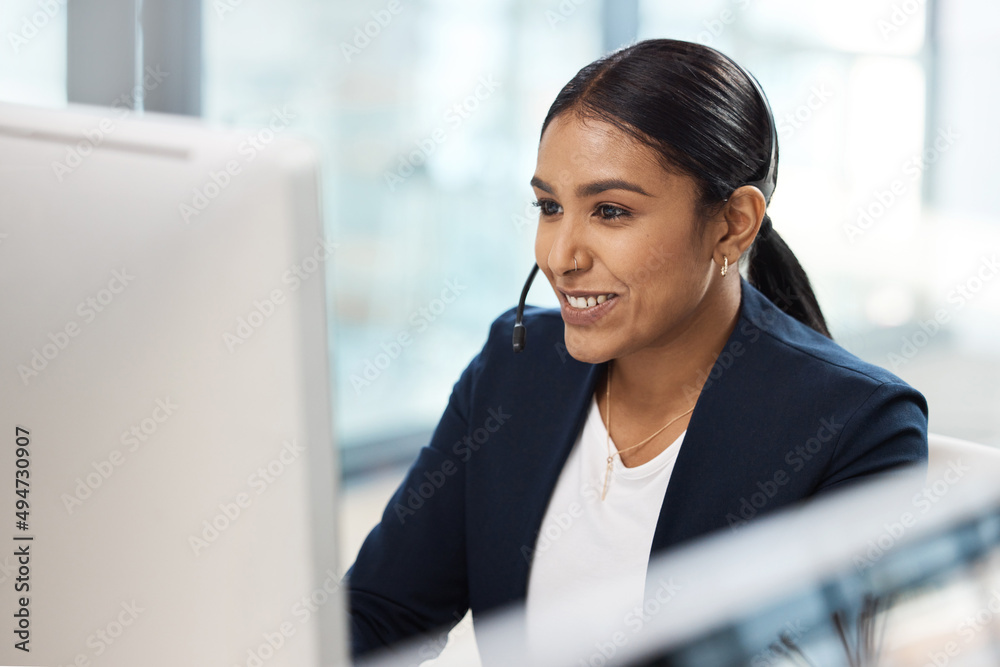 Poster she holds all the qualities of a top sales agent. shot of a young businesswoman working on a compute