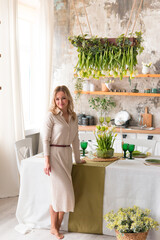 Beautiful happy woman with flowers indoors 