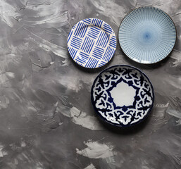 Three plates with patterns on a gray background top view
