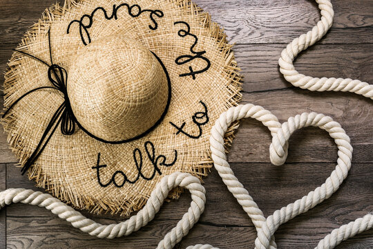 Inscription love and symbol heart made of rope on a wooden background