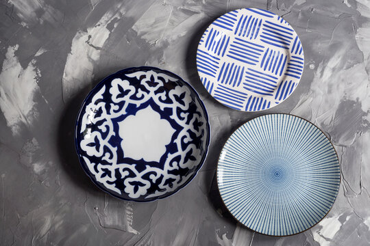 Three plates with patterns on a gray background top view