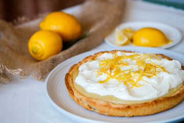 Lemon tart. Shortcrust pastry with lemon cream and whipped cream. Baked lemon pie.